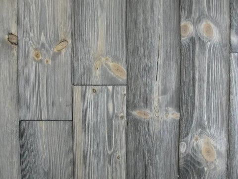 Heritage Gray Reactive Water Based VOC Free Interior Wood Stain 55 Gallon Tank on weathered gray wood planks with natural knots.