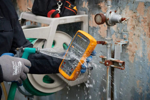 Pro Grade True RMS Digital Multimeter Kit with Premium Leads and ToolPak, IP67 Waterproof, being tested under running water