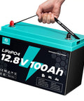 Hand holding 12V 100Ah LiFePO4 Deep Cycle Battery Group 31 With 120A BMS, 1280Wh, 15000 Plus Cycles, Low Temp Cutoff, Off Grid Ready