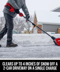 Person using Badass Brushless 40 Volt Cordless Snow Shovel Kit With A Meaty 12 Inch Deck on snowy driveway.