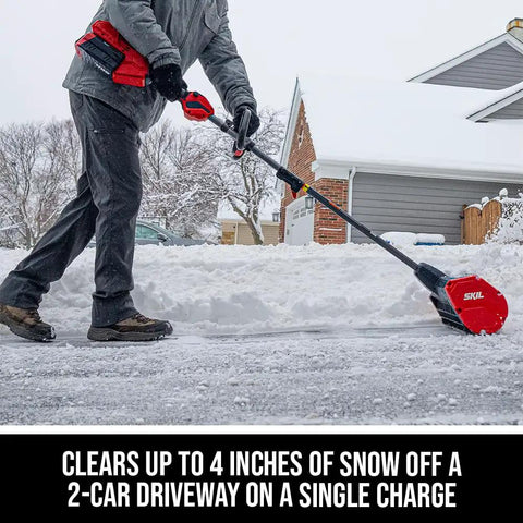 Person using Badass Brushless 40 Volt Cordless Snow Shovel Kit With A Meaty 12 Inch Deck on snowy driveway.