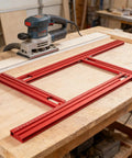 Heavy Duty Adjustable Router Jig For Cutting Boards, red aluminum frame on wooden table with router for precision cuts.