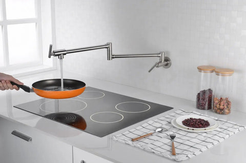 Pot Filler Faucet Wall Mount Brushed Nickel Finish With Dual Swing Joints filling a pan on a stove in a modern kitchen.