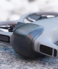 Drone Lens Cover Set For DJI NEO 2, 2 Pack Gimbal Protector Caps, attached to a NEO 2 drone on a stone surface