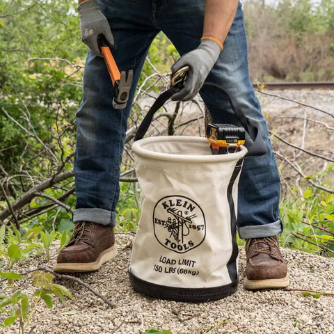 Worker using Canvas Tool Bucket With Drain Holes, Heavy Duty Canvas Pail For Tools And Gear, Plastic Bottom, 150 Pound Load Rating