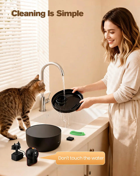 Woman cleaning Wireless Cat Water Fountain Cordless No Cords Needed Battery Operated 88 Oz Black Pet Water Dispenser with cat watching