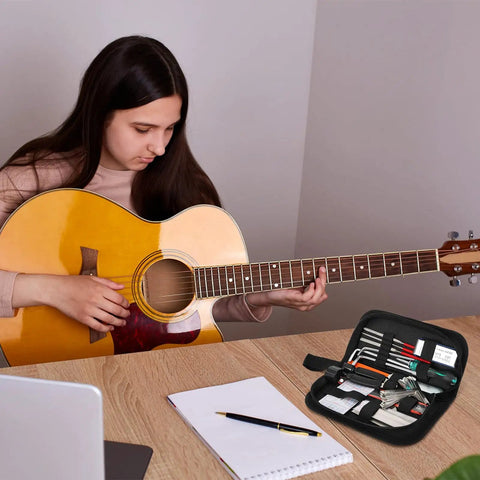 Person playing guitar with All In One 26 Piece Guitar Setup and Repair Kit with Carry Bag for Guitar Ukulele Bass Mandolin Banjo Tools visible.