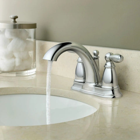 Brantford Chrome Two-Handle Low Arc Centerset Bathroom Faucet With Drain Assembly, water flowing from aerated spout