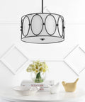 Gold 3 Light LED Pendant Light With White Linen Drum Shade Modern Hanging Chandelier For Dining Room And Kitchen Island 19 Inch Adjustable Metal Ceiling Fixture Energy Saving Lighting in modern room setting with flowers.