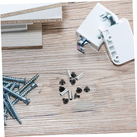 Knife handle rivet and screw repair kit, 4 pieces with metal spacers and black fasteners on wooden surface