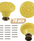 Totally Slick Yellow Ceramic Cabinet Knobs Featuring Dang Cute Embossed Floral Patterns Vintage Drawer Handles And Furniture Pulls For Kitchen Makeover Twenty Piece Pack with brass screws shown.