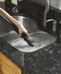 Vacuum hose cleaning soapy water in kitchen sink