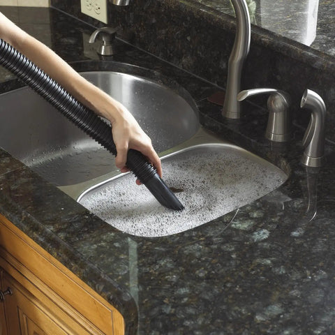 Vacuum hose cleaning soapy water in kitchen sink