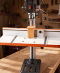Rock Solid Drill Press Table With Adjustable Fence And Wide T Slots For Locking Down Projects Dead Nuts Precise MDF Worktop showcasing a drill press table with an orange and silver frame.