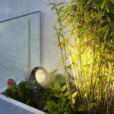 Low Voltage Landscape Spotlight Set 18W Outdoor Waterproof LED Path Lights illuminating garden with warm white glow