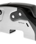 Spinlock XTR rope clutch, silver metal body with black top, angled side view.