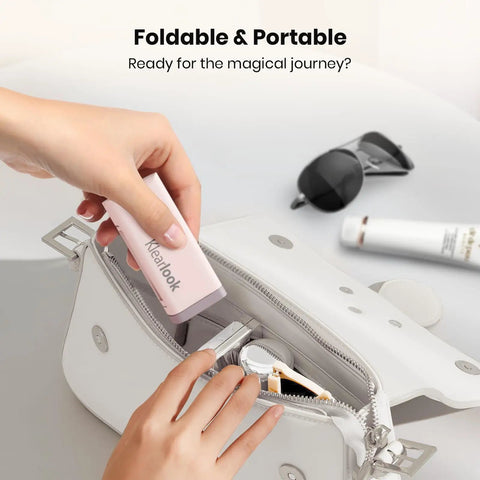 Hand placing Airplane Phone Holder Mount for Travel Must Haves in white bag, foldable and pink, with sunglasses and lipstick nearby.