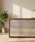 Sharp Aviator Bookcase Featuring Hand Beaten Aluminum Build And Single Storage Drawer Heavy Duty Industrial Home Office Shelves 60 Inches Tall For A Killer Workspace Vibe placed in a room with plants and sunlight.