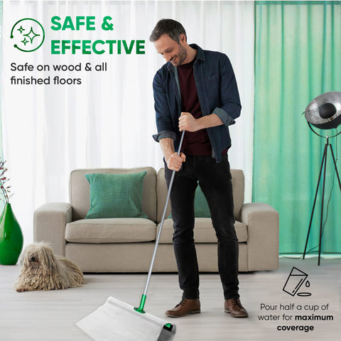 Man using huge wet floor wipes for squeegee stick, cleaning wood floor, couch and dog in the background, text overlay present.