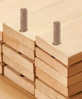100 Pack Wooden Dowel Pins 8X30MM Hardwood Twist Groove Pegs With Tapered Ends installed in predrilled holes of stacked wood pieces.