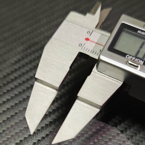 Close-up of Blade Style Electronic Caliper For Small Grooves, Stainless Steel Measuring Tool, 6 Inch 150mm Range on carbon surface