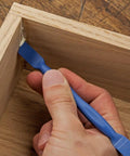 Applying glue with blue reusable glue spreader paddles set of three with four tip widths one eighth to one half inch for precise glue application reaching tight corners handy grip and easy to clean glue tool for grooves dados and more.