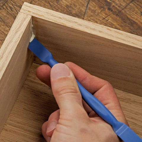 Applying glue with blue reusable glue spreader paddles set of three with four tip widths one eighth to one half inch for precise glue application reaching tight corners handy grip and easy to clean glue tool for grooves dados and more.