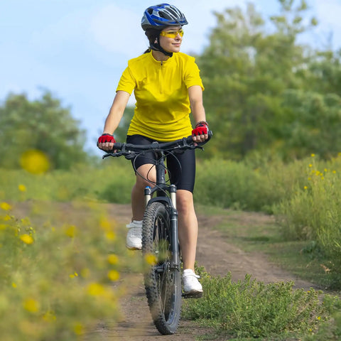 Cyclist riding on gravel path showcasing Two Pack 24 Inch Heavy Duty Bike Tubes With AV32mm Schrader Valve Fits 24x2.10 To 24x2.40 Tires