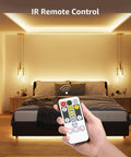 LED Tunable White Strip Light 32.8ft With 600 2835 LEDs illuminating a bedroom with remote control in hand