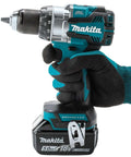 Kickin Amp 18V Brushless Cordless Drill Driver with metal chuck held in gloved hand, ideal for construction sites.