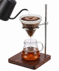 Solid Black Walnut Pour Over Coffee Maker Stand With Adjustable Stainless Steel Dripper Holder brewing coffee into glass carafe.