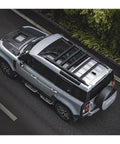 Heavy Duty Aero Roof Rack Built For Land Rover Defender 110 on silver vehicle, designed for hauling, reducing wind drag.