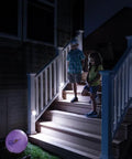 Wireless Battery Operated Indoor Outdoor Motion Sensor LED Stair Light 2 Pack illuminating stairs at night with kids descending