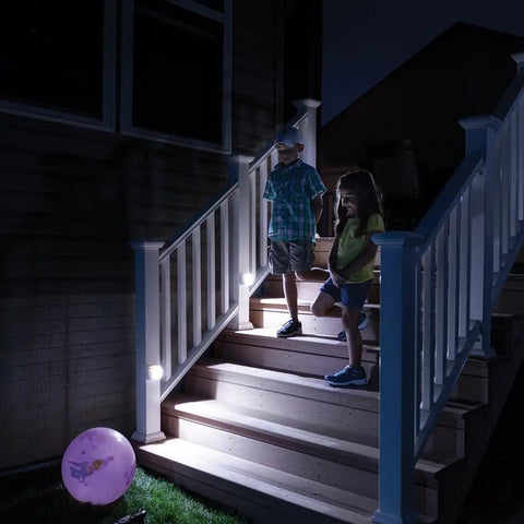 Wireless Battery Operated Indoor Outdoor Motion Sensor LED Stair Light 2 Pack illuminating stairs at night with kids descending