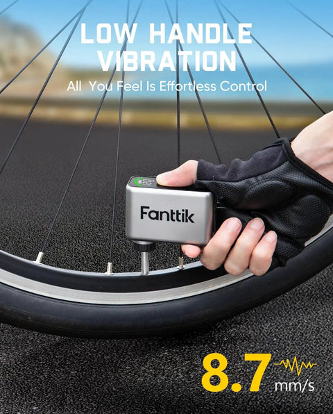 Hand using Tiny But Mighty Mini Electric Bike Pump With 120 PSI Presta And Schrader Valve Fast Inflate Ultra Portable for road bikes.