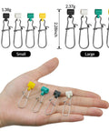 Sinker Slides For Fishing Rigs 25 Piece Duo Lock Snaps Set, Heavy Duty Weights And Saltwater Connectors, Durable Plastic And Stainless Steel, Rustproof And Corrosion Resistant, Fast Rig Swaps For Saltwater Angling displayed on hand.