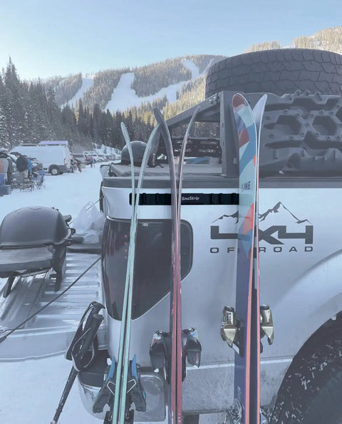 Badass Magnetic Ski And Snowboard Vehicle Rack Keeping Your Ride Spotless With Soft Waterproof Padding For Reliable All Season Winter Storage And Trail Ready Adventures with skis mounted on truck.
