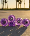 82A Purple Glitter Quad Roller Skate Wheels Four Pack For Indoor Outdoor Use on pavement with sunset in background