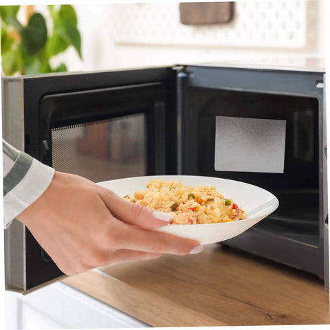 Person placing dish in microwave with 10 Piece Microwave Waveguide Covers Set 5.9 By 4.7 Inches Each Mica Sheet Easy To Cut installed.