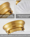 Close-up of gold finish schoolhouse light fixture with opal milk glass shade, showing details and materials.