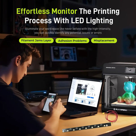 Man monitoring 3D print with laptop, Adventurer 5M Pro printer illuminated by Lit LED Light Strip For Adventurer 5M Pro 3D Printer