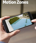 Ring Floodlight Cam Wired Plus outdoor security camera, white; front view of a smartphone showing motion-zone overlay