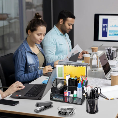 All In One Black Desk Organizer Set For Home Office And School on a desk with people working in the background, office supplies visible