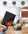 Hand using 4 Pack Screen Cleaning Pad With Elastic Strap Soft Microfiber Wipes For iPad iPhone MacBook Tablets And Laptops Clean Smudges Fast And Easy With A Premium Vegan Leather Back No Mess Cleanup on tablet screen.