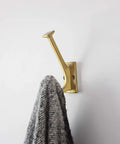 Skylight Collection Wall Hooks For Coats Hats Towels Robes And More Four And Seven Eighths Inch Long Brushed Golden Brass 14 Pack in use