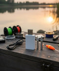 Smart LED CR322 Battery Charger Set with USB Power on fishing box with night floats and bobbers, lakeside at sunset.