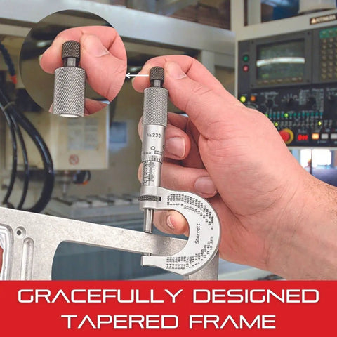 Hand using Beefy Outside Micrometer With One Piece Spindle, Satin Chrome Finish, measuring metal part in machine shop setting.