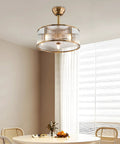 Vintage Industrial Caged Ceiling Fan Light Fixture with Remote,7-Blade Fan in gold finish, featuring a glass enclosure, above a dining table.