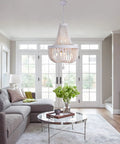 Six Light Boho Wood Beaded Chandelier Rustic Farmhouse Pendant Light For Dining Room Kitchen Living Room Hallway Foyer Entryway White Diameter 18.5 Inches hanging in a living room.