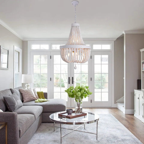 Six Light Boho Wood Beaded Chandelier Rustic Farmhouse Pendant Light For Dining Room Kitchen Living Room Hallway Foyer Entryway White Diameter 18.5 Inches hanging in a living room.